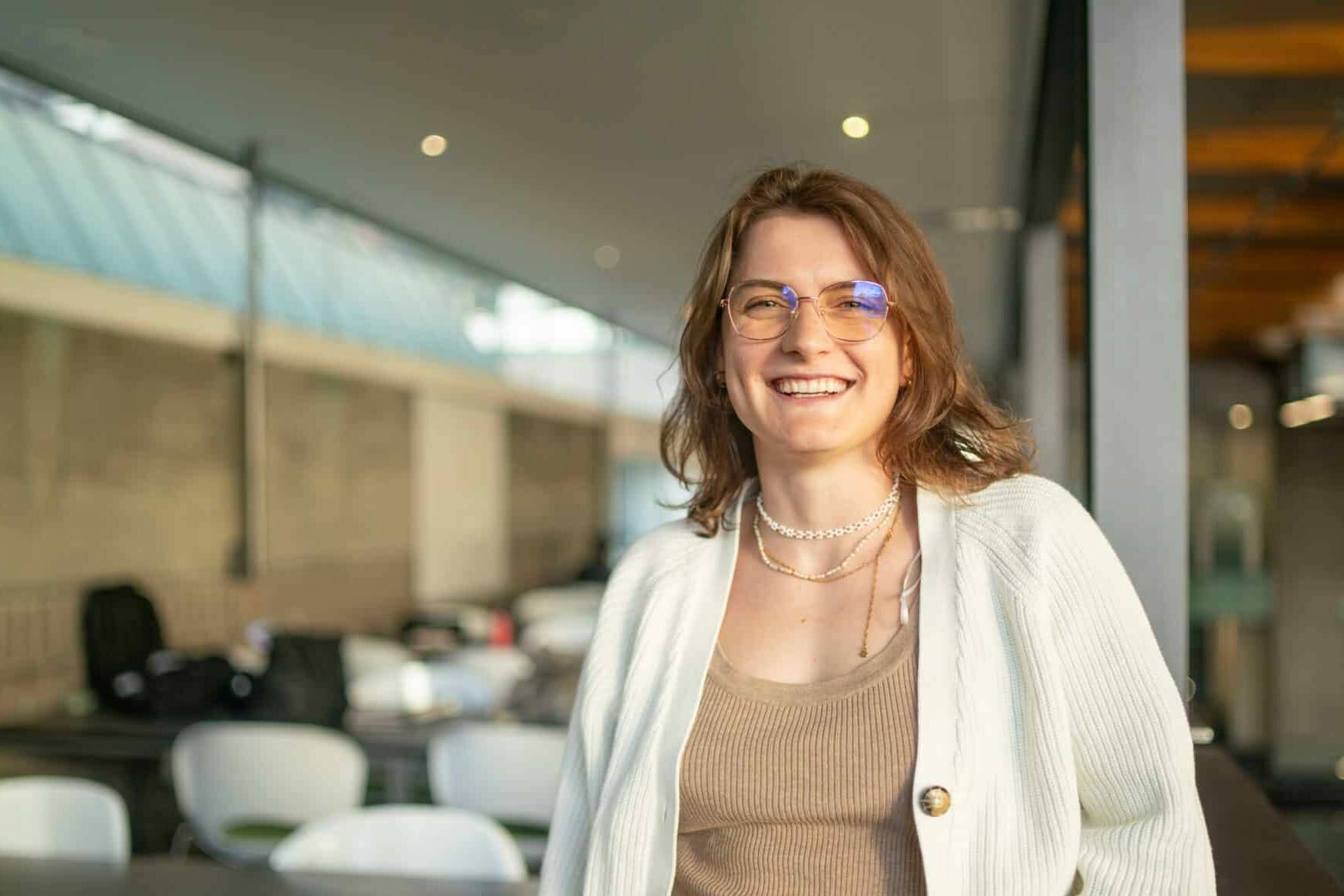 A confident woman smiles at the camera | TMNZ Tax Finance