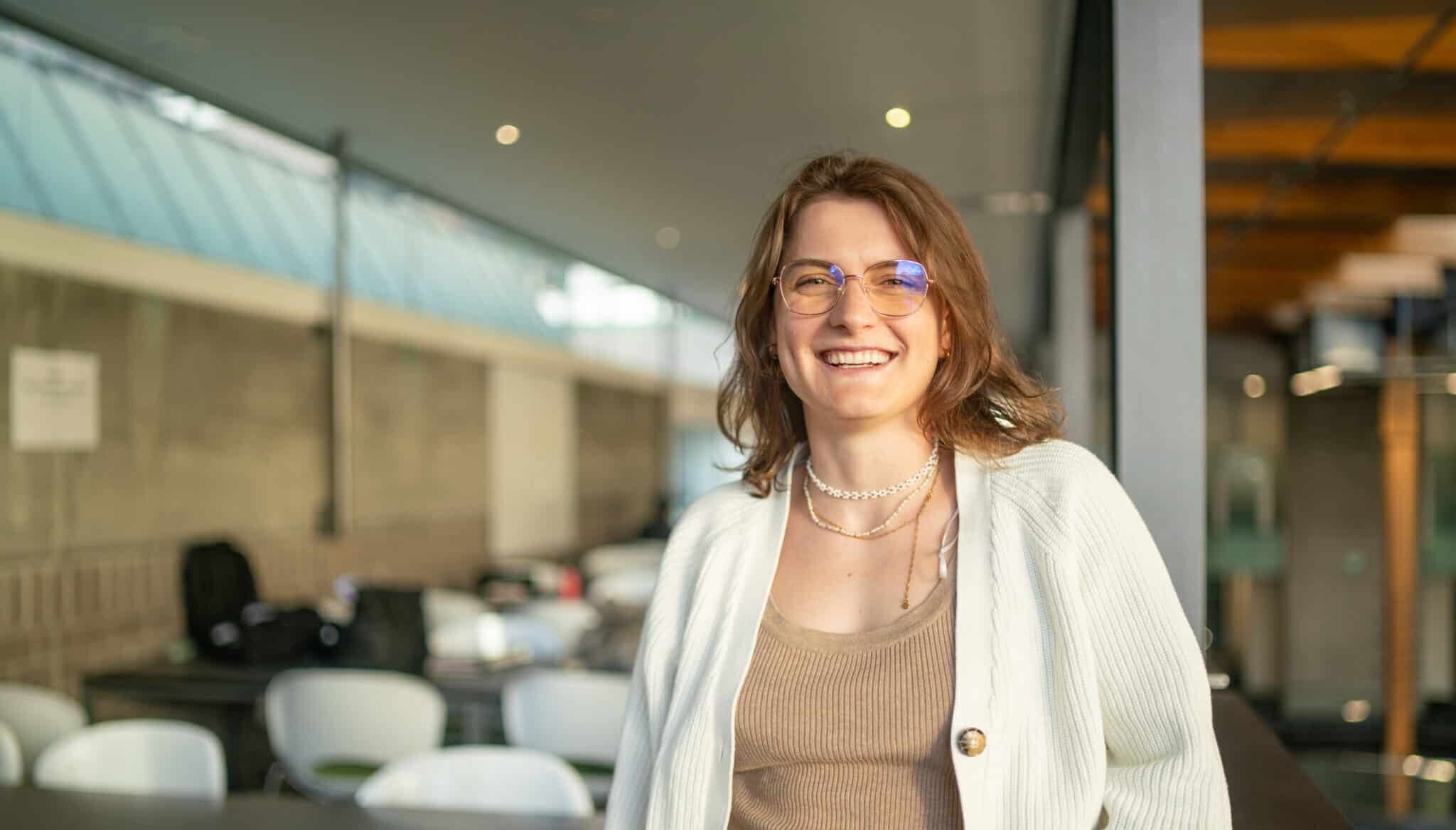 A confident woman smiles at the camera | TMNZ Tax Finance